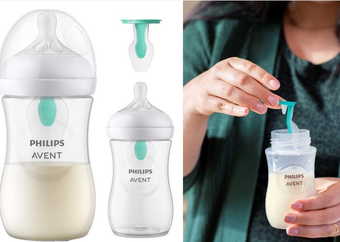 Mother filling baby bottle